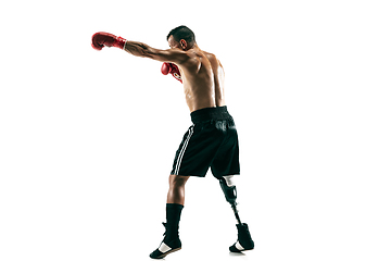 Image showing Full length portrait of muscular sportsman with prosthetic leg, copy space. Male boxer in red gloves.