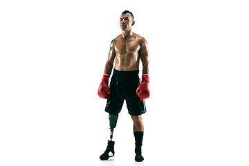 Image showing Full length portrait of muscular sportsman with prosthetic leg, copy space. Male boxer in red gloves.