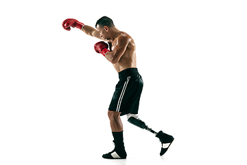 Image showing Full length portrait of muscular sportsman with prosthetic leg, copy space. Male boxer in red gloves.