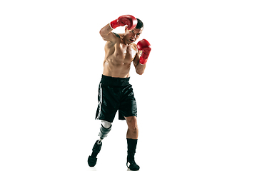 Image showing Full length portrait of muscular sportsman with prosthetic leg, copy space. Male boxer in red gloves.