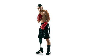 Image showing Full length portrait of muscular sportsman with prosthetic leg, copy space. Male boxer in red gloves.