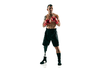 Image showing Full length portrait of muscular sportsman with prosthetic leg, copy space. Male boxer in red gloves.