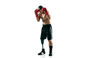 Image showing Full length portrait of muscular sportsman with prosthetic leg, copy space. Male boxer in red gloves.