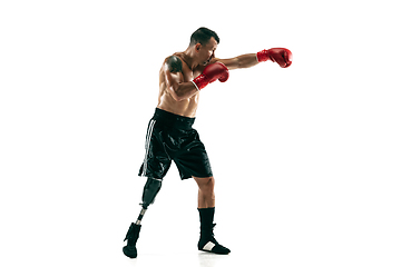 Image showing Full length portrait of muscular sportsman with prosthetic leg, copy space. Male boxer in red gloves.