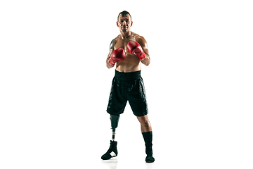 Image showing Full length portrait of muscular sportsman with prosthetic leg, copy space. Male boxer in red gloves.