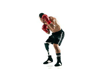 Image showing Full length portrait of muscular sportsman with prosthetic leg, copy space. Male boxer in red gloves.