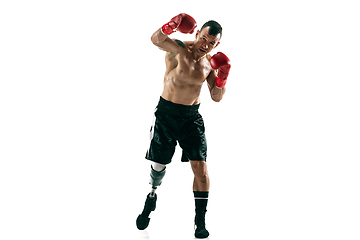 Image showing Full length portrait of muscular sportsman with prosthetic leg, copy space. Male boxer in red gloves.