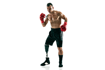 Image showing Full length portrait of muscular sportsman with prosthetic leg, copy space. Male boxer in red gloves.