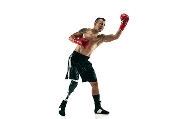 Image showing Full length portrait of muscular sportsman with prosthetic leg, copy space. Male boxer in red gloves.