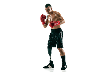 Image showing Full length portrait of muscular sportsman with prosthetic leg, copy space. Male boxer in red gloves.