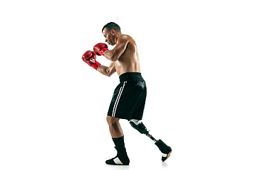 Image showing Full length portrait of muscular sportsman with prosthetic leg, copy space. Male boxer in red gloves.