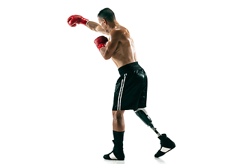 Image showing Full length portrait of muscular sportsman with prosthetic leg, copy space. Male boxer in red gloves.