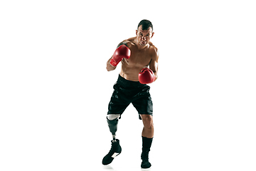 Image showing Full length portrait of muscular sportsman with prosthetic leg, copy space. Male boxer in red gloves.