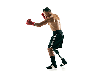 Image showing Full length portrait of muscular sportsman with prosthetic leg, copy space. Male boxer in red gloves.