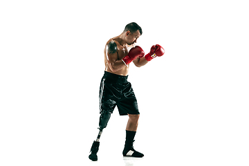 Image showing Full length portrait of muscular sportsman with prosthetic leg, copy space. Male boxer in red gloves.