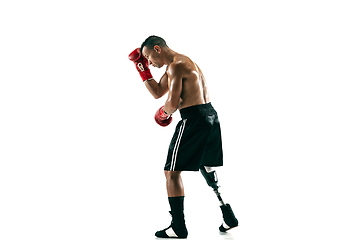 Image showing Full length portrait of muscular sportsman with prosthetic leg, copy space. Male boxer in red gloves.