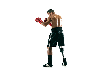 Image showing Full length portrait of muscular sportsman with prosthetic leg, copy space. Male boxer in red gloves.