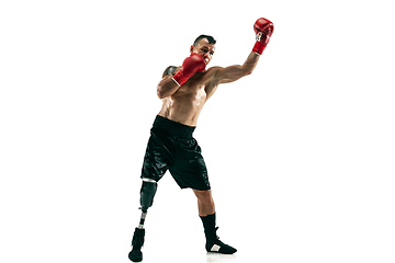 Image showing Full length portrait of muscular sportsman with prosthetic leg, copy space. Male boxer in red gloves.