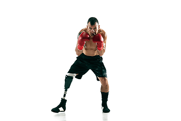 Image showing Full length portrait of muscular sportsman with prosthetic leg, copy space. Male boxer in red gloves.