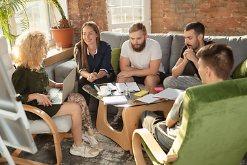 Image showing Group of young caucasian office workers have creative meeting to discuss new ideas