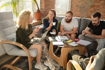 Image showing Group of young caucasian office workers have creative meeting to discuss new ideas