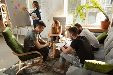 Image showing Group of young caucasian office workers have creative meeting to discuss new ideas