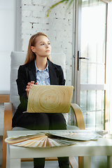 Image showing Interior designer working in modern office. Young business woman in contemporary interior.