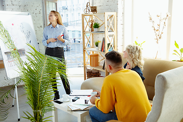 Image showing Interior designer working with young couple. Lovely family and professional designer or architector.