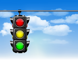 Image showing Traffic lights with all three colors on hanging against blue sky