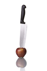 Image showing Knife cutting an apple