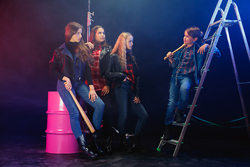 Image showing Full length portrait of cute little kids in stylish jeans clothes looking at camera and smiling, standing against white brick wall