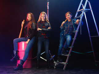 Image showing Full length portrait of cute little kids in stylish jeans clothes looking at camera and smiling, standing against white brick wall