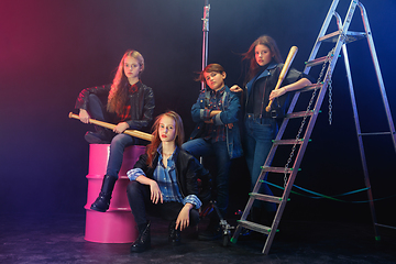 Image showing Full length portrait of cute little kids in stylish jeans clothes looking at camera and smiling, standing against white brick wall