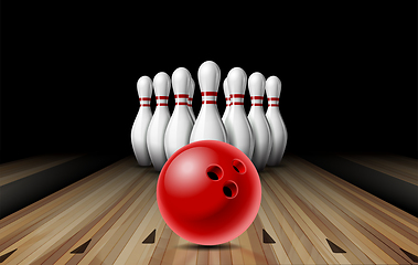 Image showing Red glossy ball rolling on bowling alley line to ten placed in order white bowling pins.