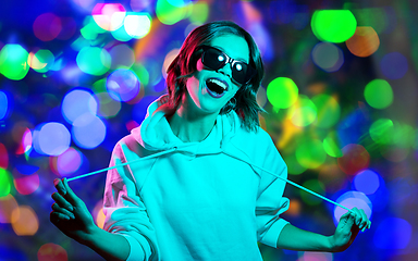 Image showing woman in hoodie and sunglasses over night lights