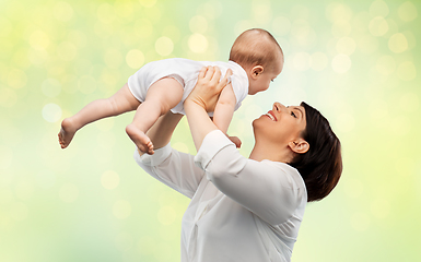 Image showing happy middle-aged mother with little baby daughter