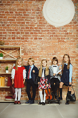 Image showing Group of kids spending time after school together. Handsome friends resting after classes.