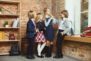 Image showing Group of kids spending time after school together. Handsome friends resting after classes.