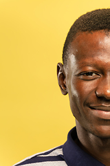 Image showing African-american young man\'s close up portrait on yellow background