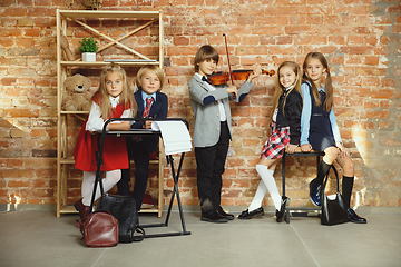 Image showing Group of kids spending time after school together. Handsome friends resting after classes.