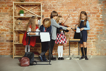 Image showing Group of kids spending time after school together. Handsome frie