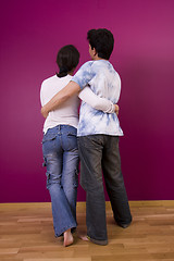 Image showing Couple looking to a painted wall