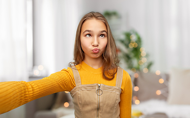 Image showing funny teenage girl taking selfie at home