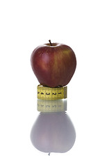 Image showing Red apple over a measure tape