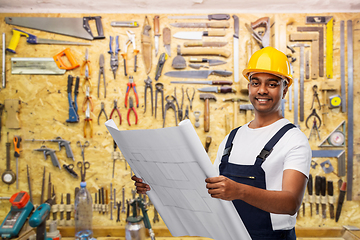 Image showing happy indian builder in helmet with blueprint