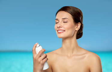 Image showing beautiful young woman with facial spray or mist