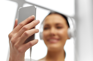 Image showing close up of woman with smartphone and headphones