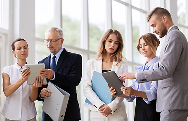 Image showing business team with tablet pc and folders at office