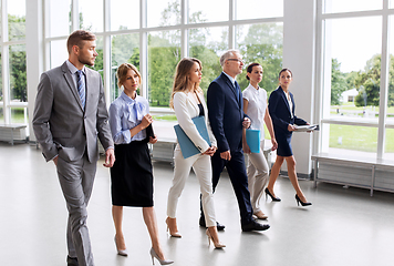 Image showing business people walking along office building