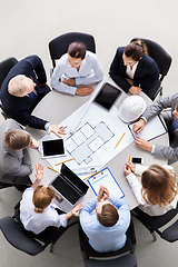 Image showing architects with laptop and blueprint at office